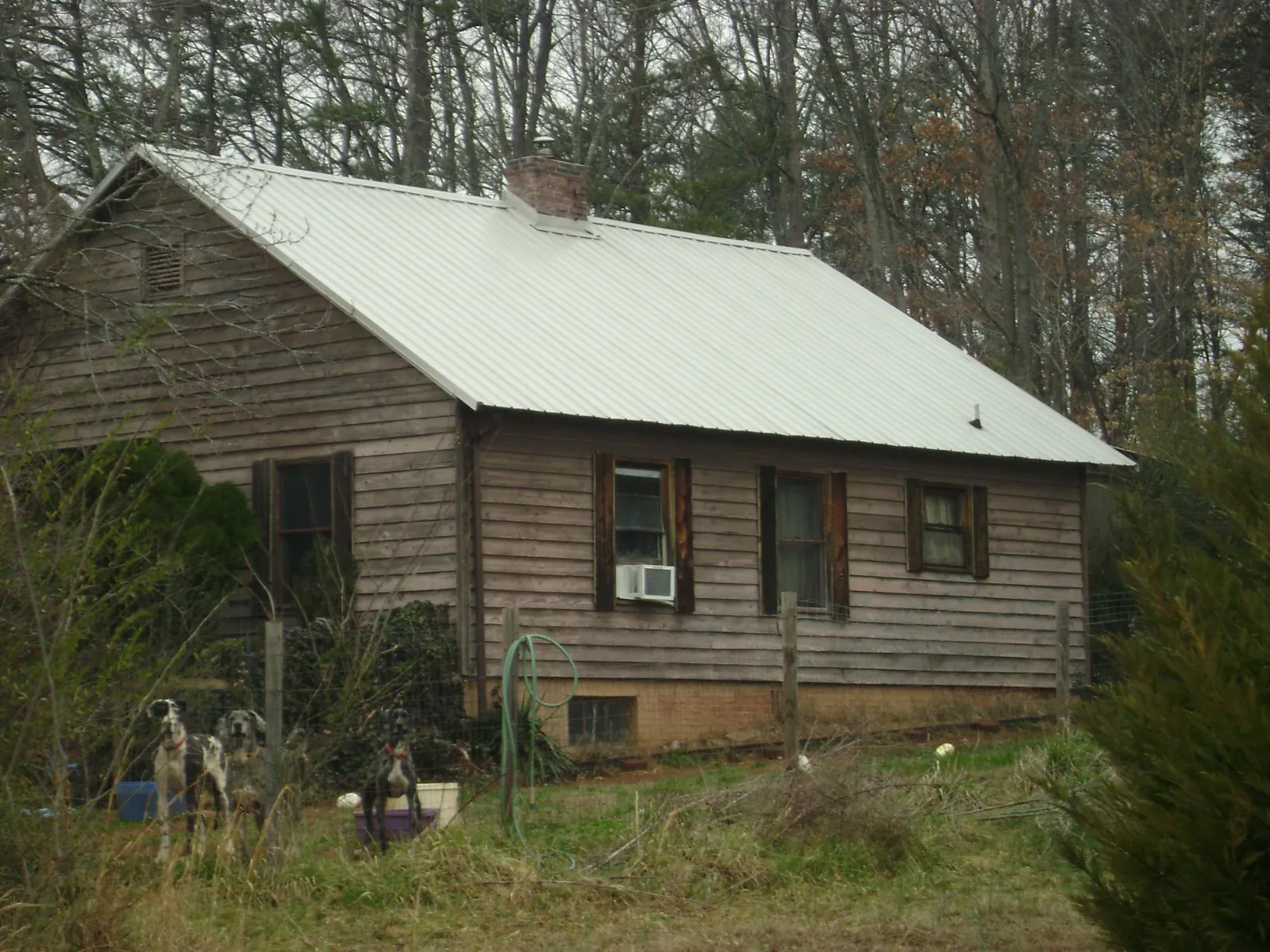 White metal roof on an old wood sided farmhouse, from a Metal Roof Installation job in Richland